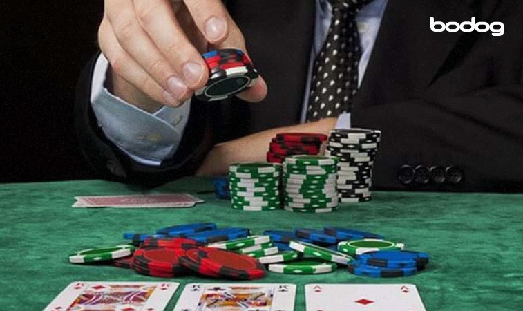 hombre poniendo fichas de poker sobre la mesa