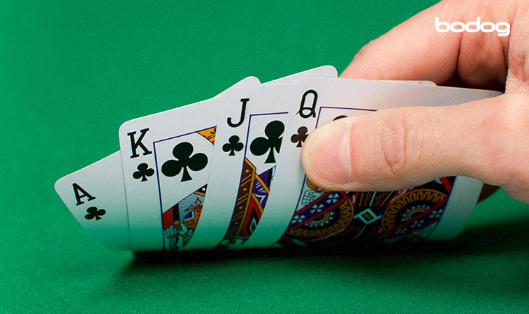 Homem segurando cartas de baralho em jogo de poker